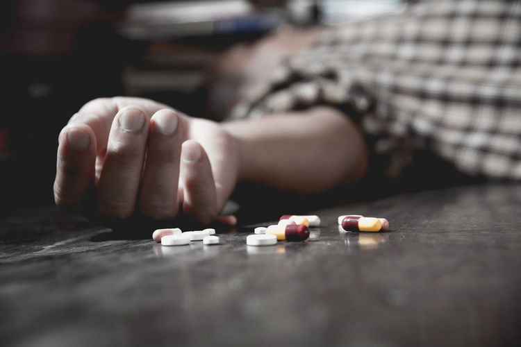 Dead man with medicines lying on floor at home