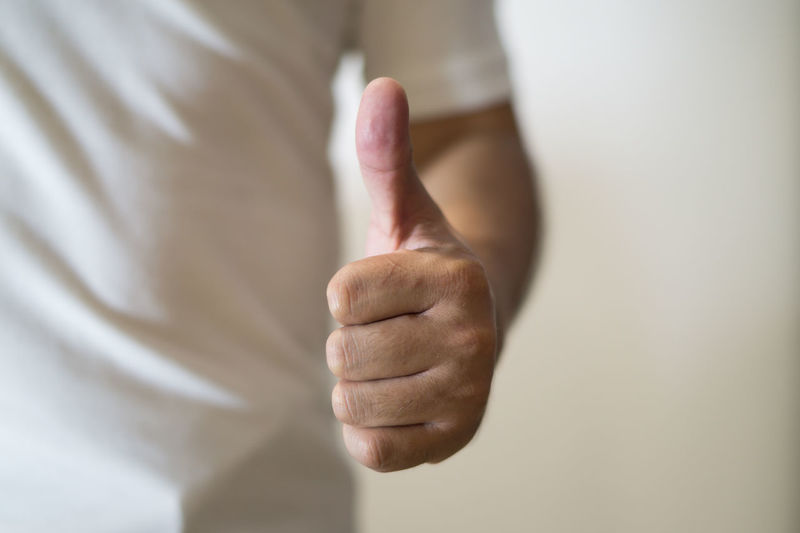 Cropped image of man gesturing thumbs up