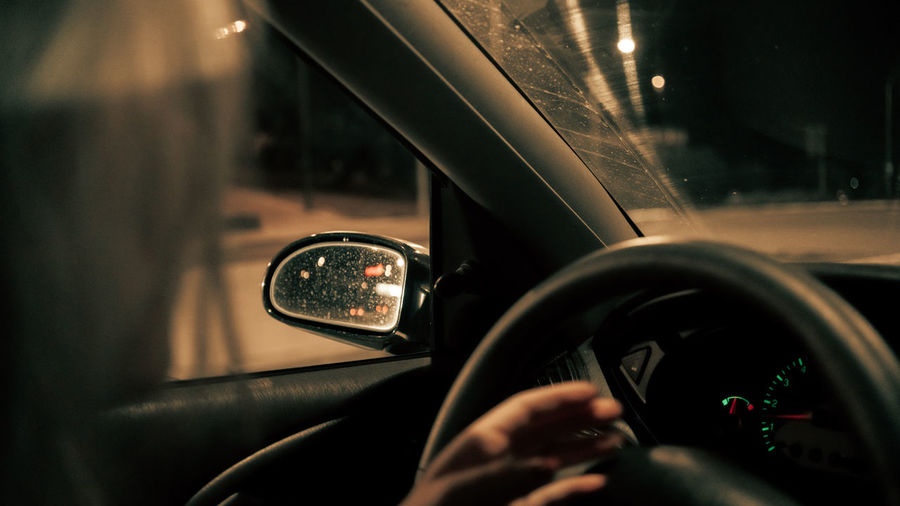 Person seen through car windshield