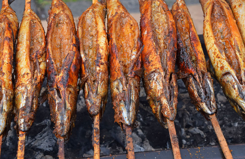 High angle view of fishes on barbecue grill