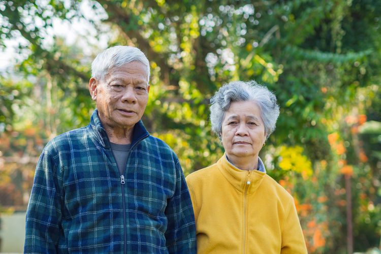 Portrait of senior couple smiling at home garden.