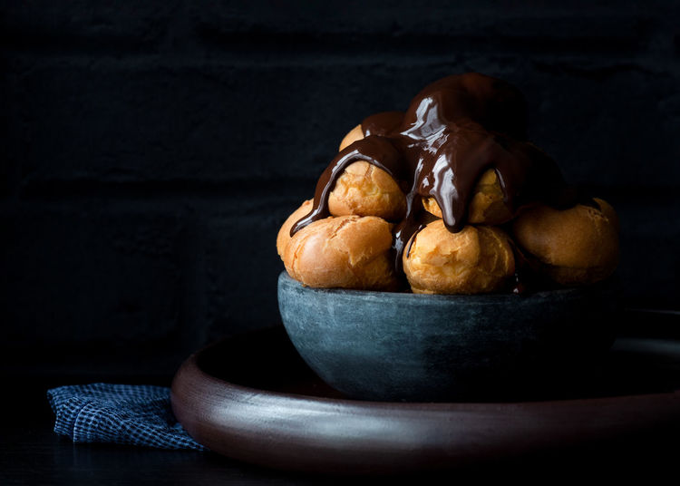 Profiteroles , choux pastry covered in a dark rich chocolate sauce