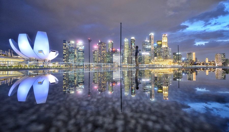 Illuminated modern buildings in city at night