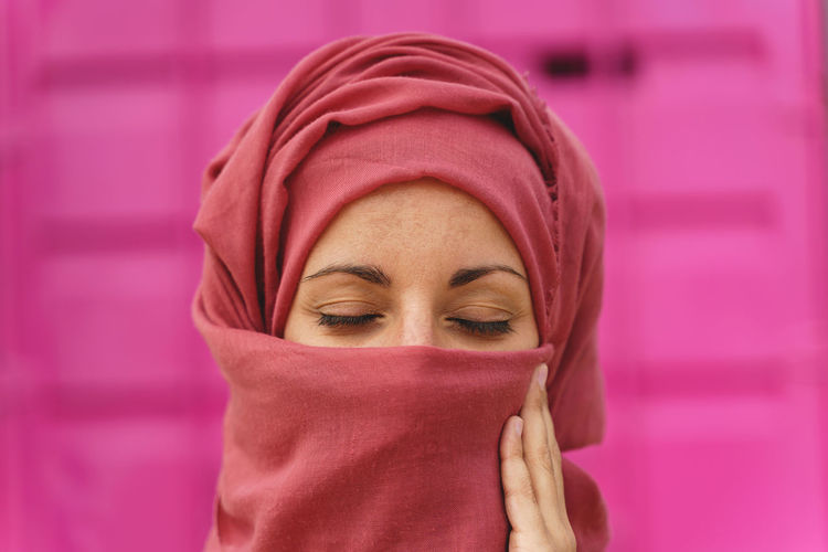 Horizontal portrait of muslim woman wearing hiyab with eyes closed. cultural diversity and religion.