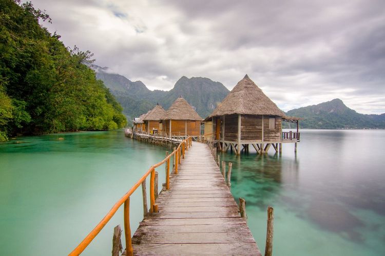 Scenic view of lake and buildings against sky