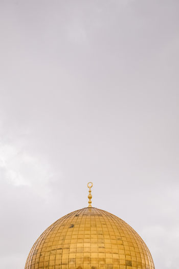 High section of traditional building against sky