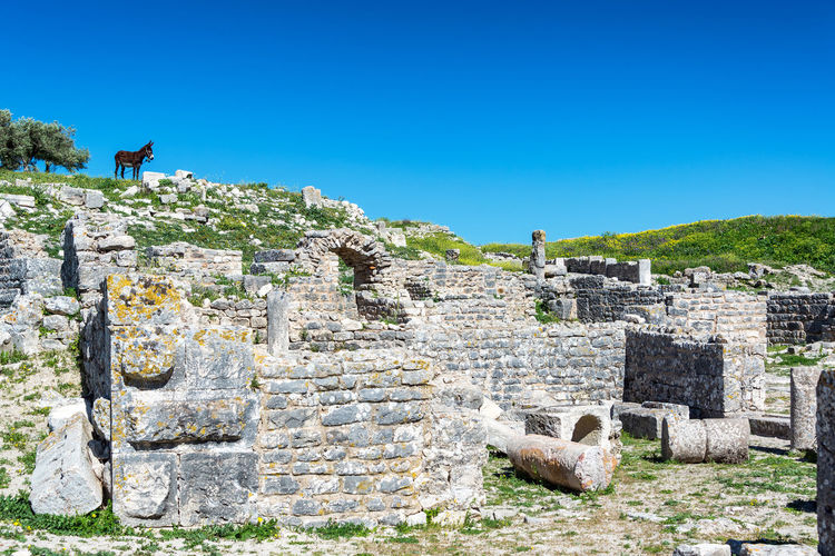 View of old ruins against clear blue sky
