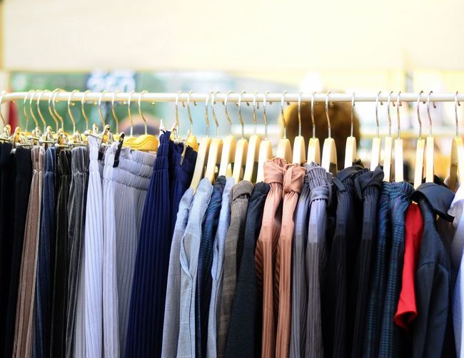 Close-up of clothes hanging on rack at store