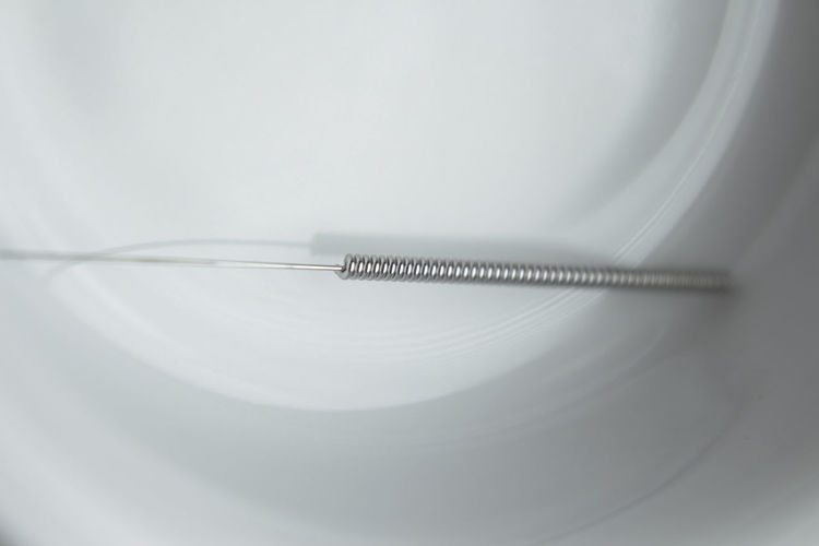 High angle view of acupuncture needle in bowl