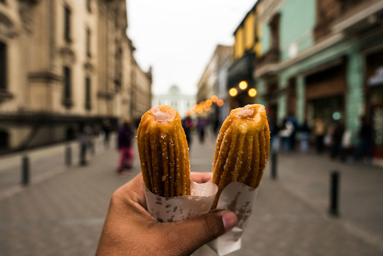 Cropped hand holding churros