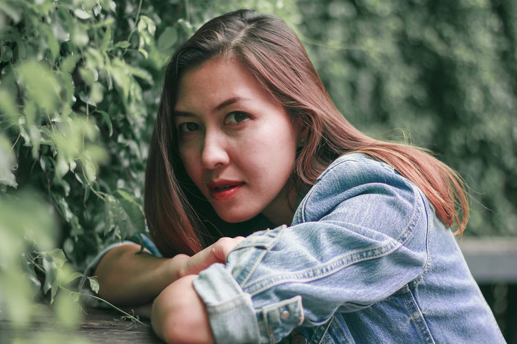 Portrait of beautiful woman by plants