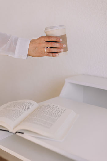 Midsection of businessman and colleague working on table