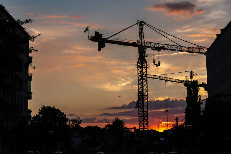 Construction site sunset with cranes