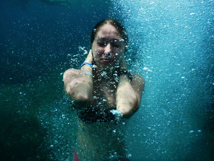 Young woman swimming in undersea