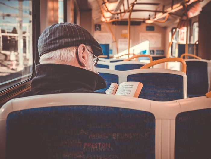 Man reading book on the train.