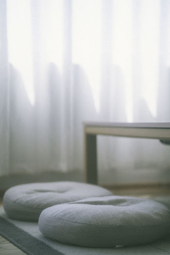 Close-up of curtain on bed at home