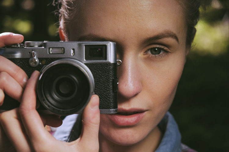 Portrait of woman photographing