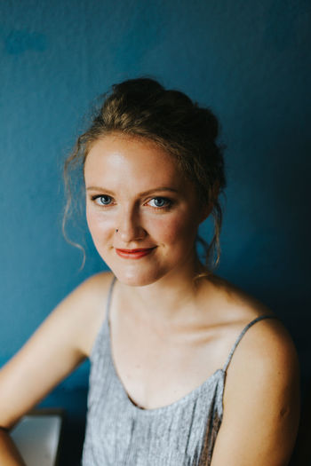 Portrait of smiling young woman at cafe