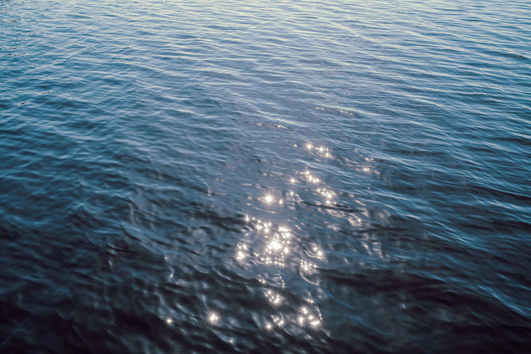 Blue rippled water with reflections of sunlight
