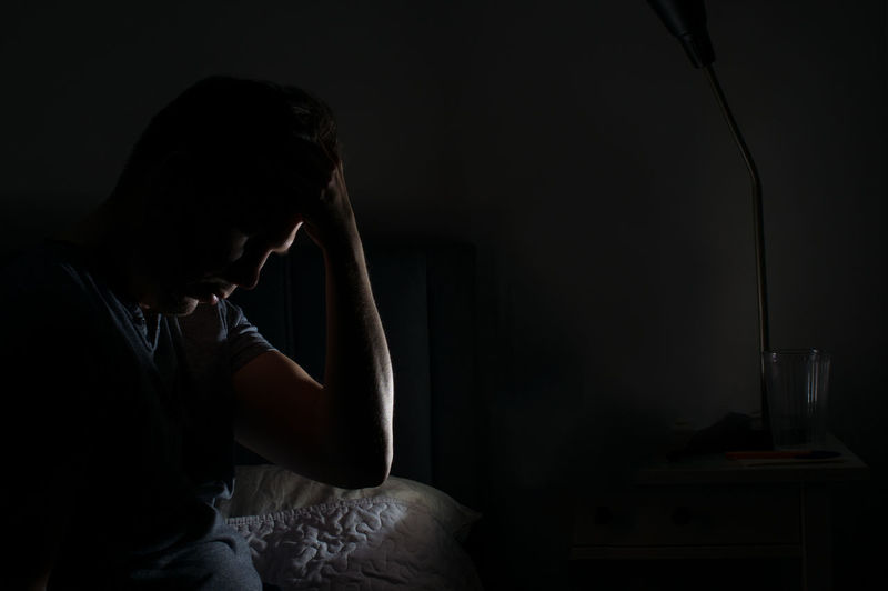 Depressed man in bedroom