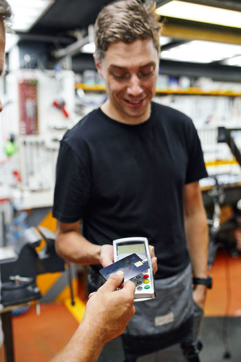 Portrait of man using mobile phone in gym