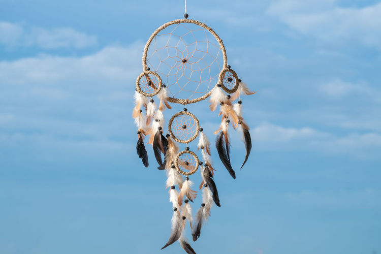Low angle view of dreamcatcher hanging against sky