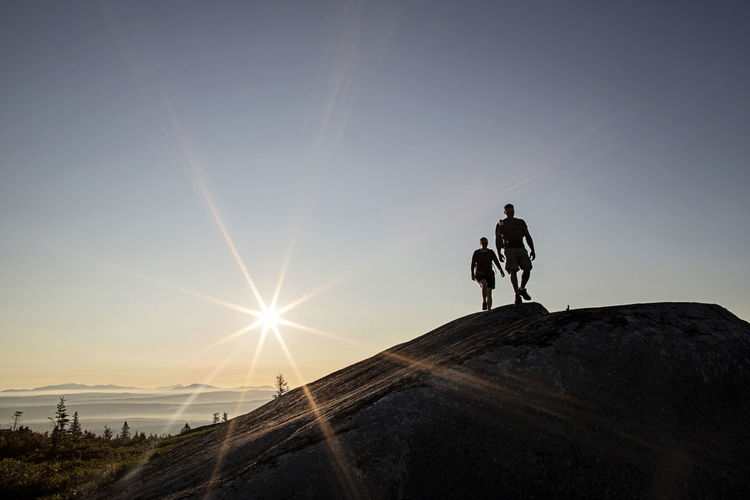 Two hikers walk above tree line on moxie bald mountain in maine.