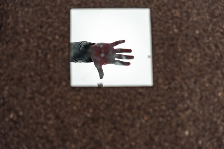 Close-up of hand on glass