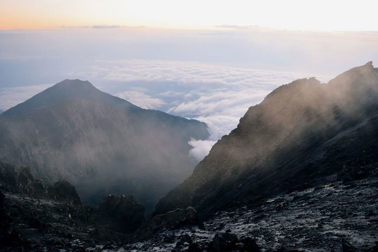 Scenic view of mountain range against sky, sunrise above the clouds, mount meru, tanzania 