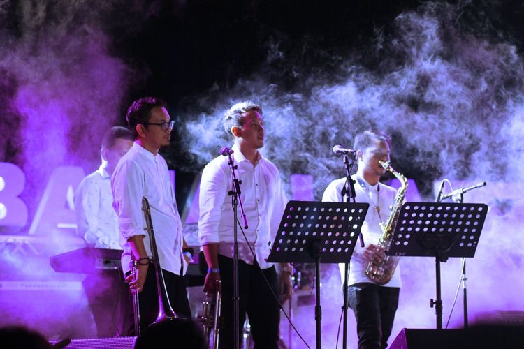 Male musicians performing on stage at night