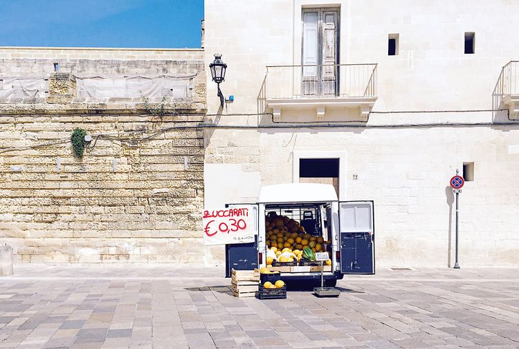 Fruits in van for sale against building