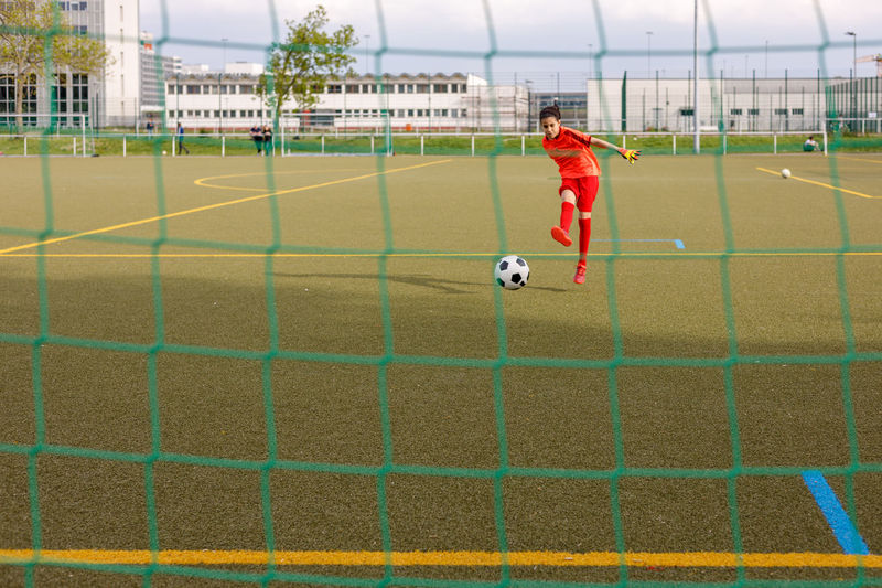Rear view of man playing soccer