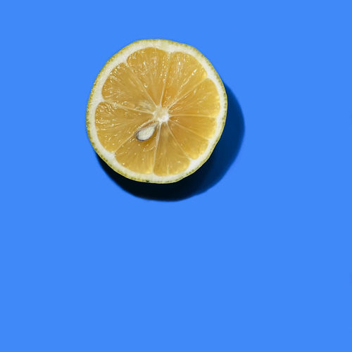Close-up of lemon slices against blue background