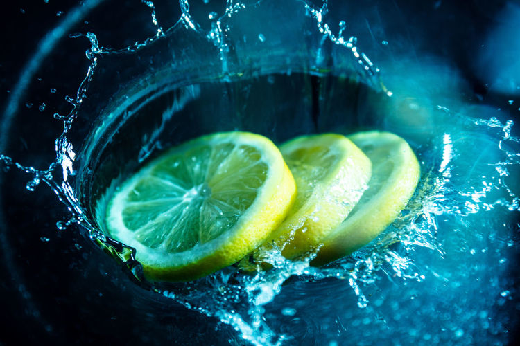 Close-up of lemons splashing in water