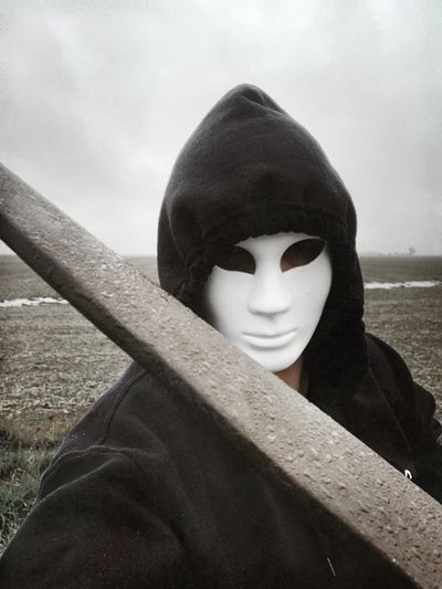 Close-up portrait of man against sky