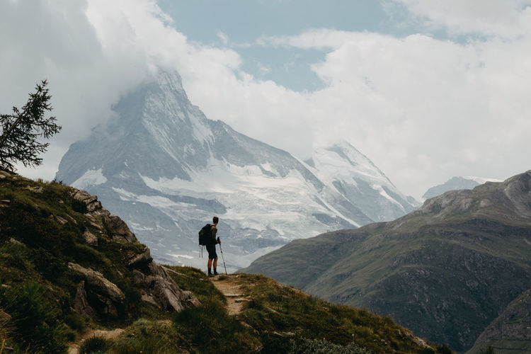 Man looking at view while standing on mountain