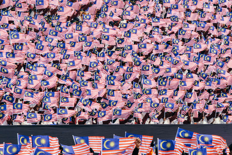 People with malaysian flags during parade