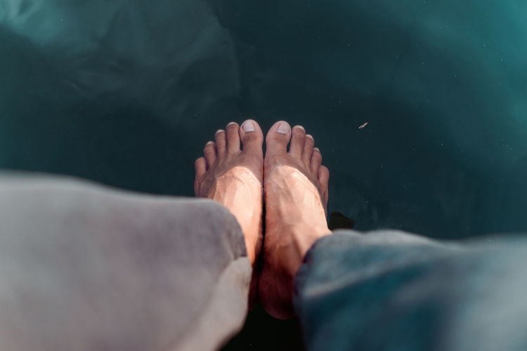 Low section of woman legs in water