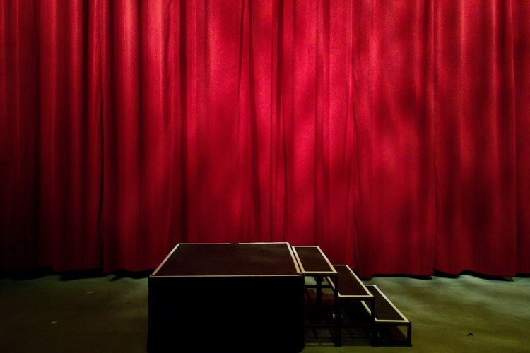 Red curtain hanging on stage