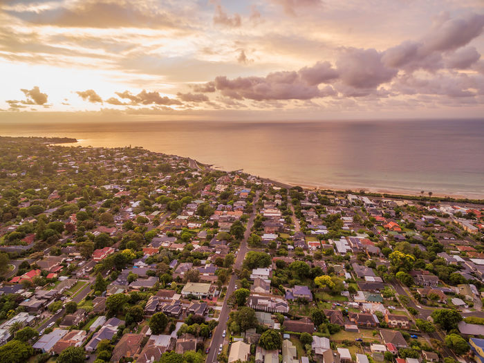 Aerial view of residential area near coastline at sunset
