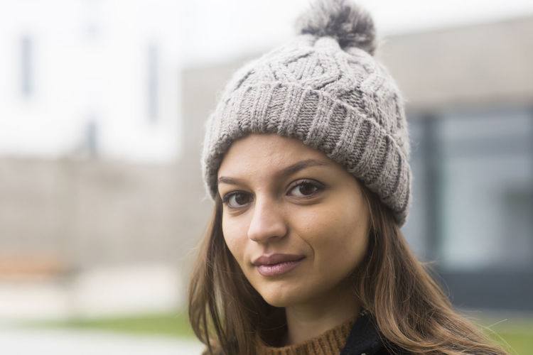 Close-up portrait of young woman in park during winter