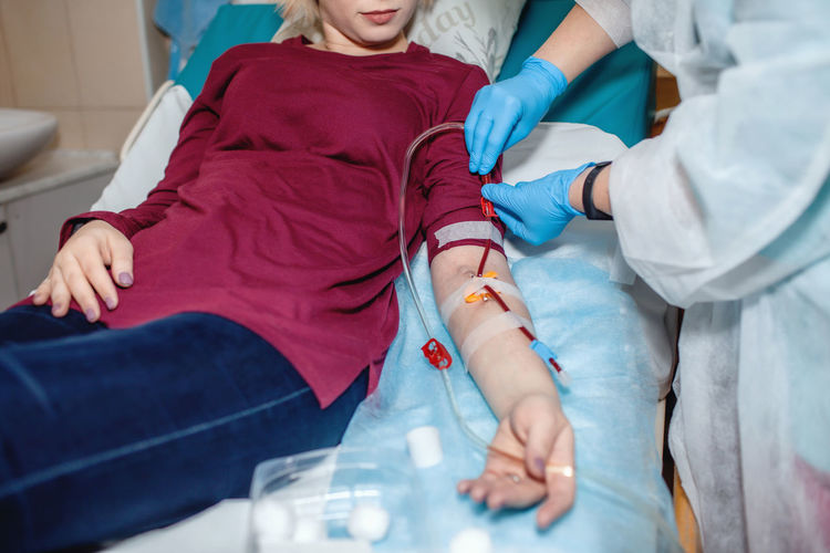 Young beautiful girl, during hemodialysis in hospital, dialysis system equipment