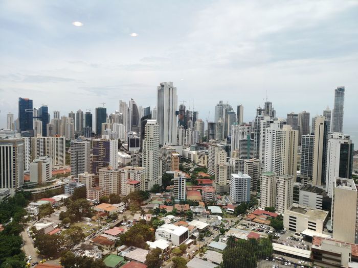 High angle view of modern buildings in city against sky