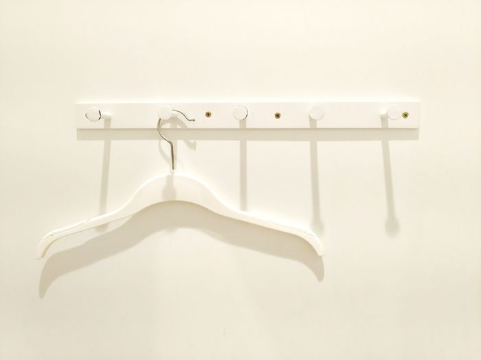 Close-up of empty hanging over white background