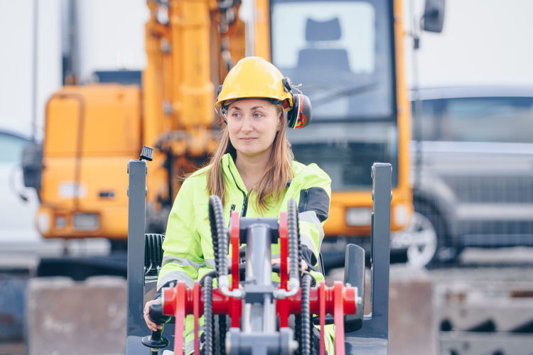 Woman with machinery at construction site