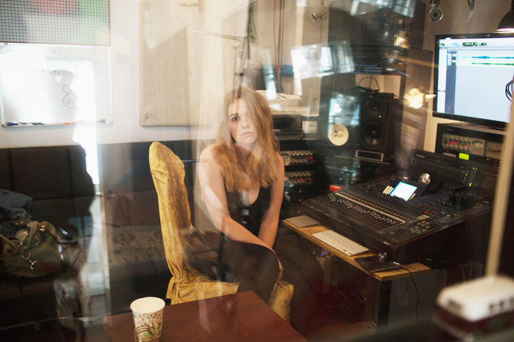 Young woman recording at a studio