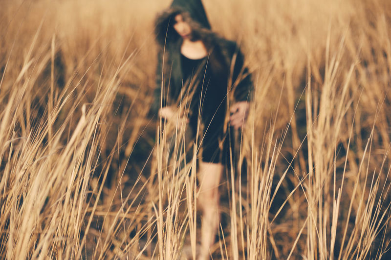 Woman walking on grassy field