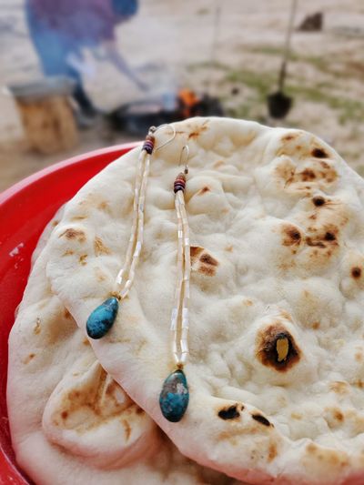 High angle view of necklace on flatbread