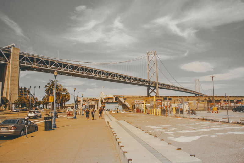 View of suspension bridge against cloudy sky
