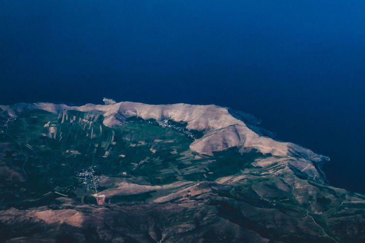Aerial view of mountains and blue sea